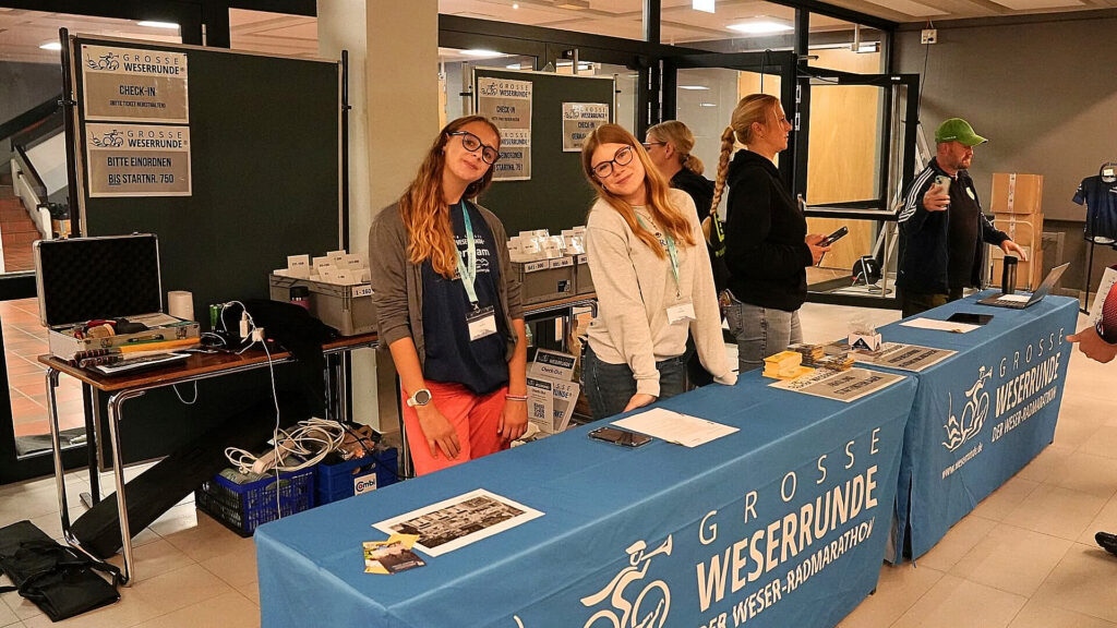 Check-in der Großen Weserrunde mit Helferinnen und Helfern im Eingangsbereich der Veranstaltung.